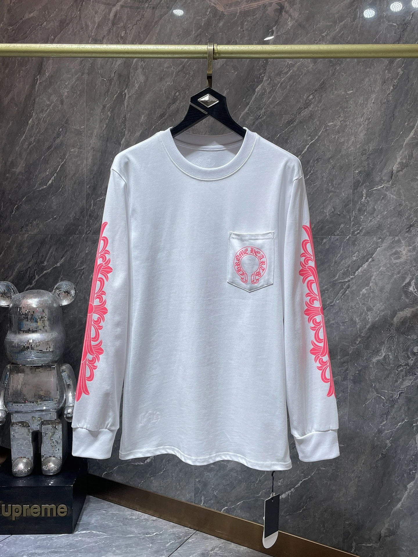 White long-sleeve tee with pink print, front